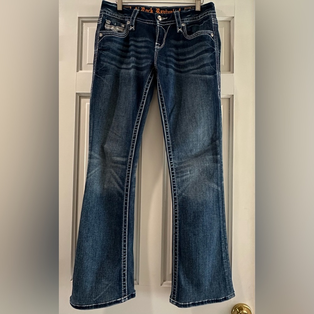Rock Revival dark blue denim jeans with subtle distressed accents, size 27.